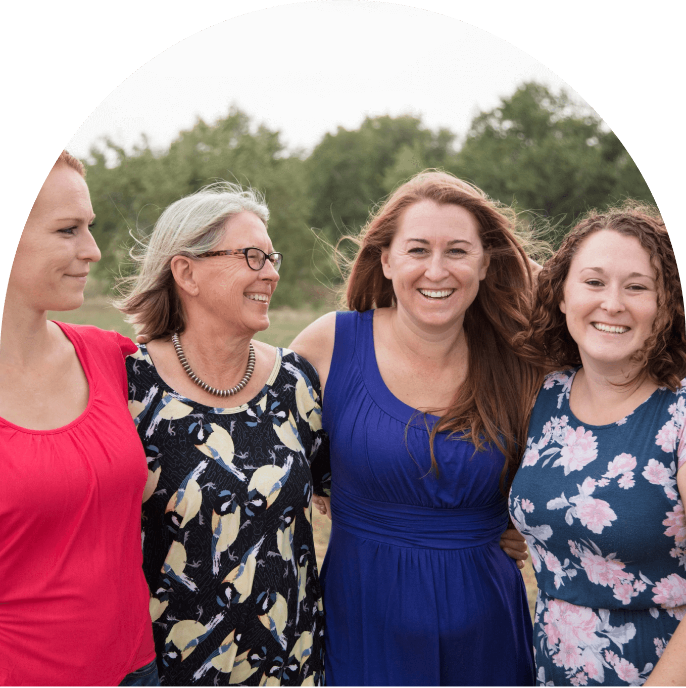 4 women standing close together, like friends